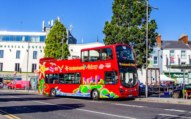 Red double-decker bus on Galway Hop-On-Hop-Off Tour near Imperial Hotel.