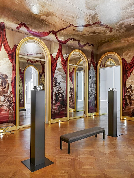 Carnavalet Museum exhibition room with ornate mirrors and historical murals.