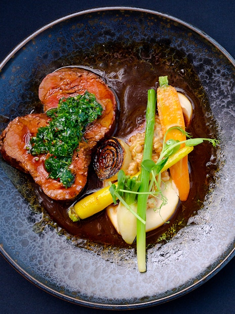 Dinner plate with beef, carrots, and greens at Altitude dining, Melbourne Skydeck.
