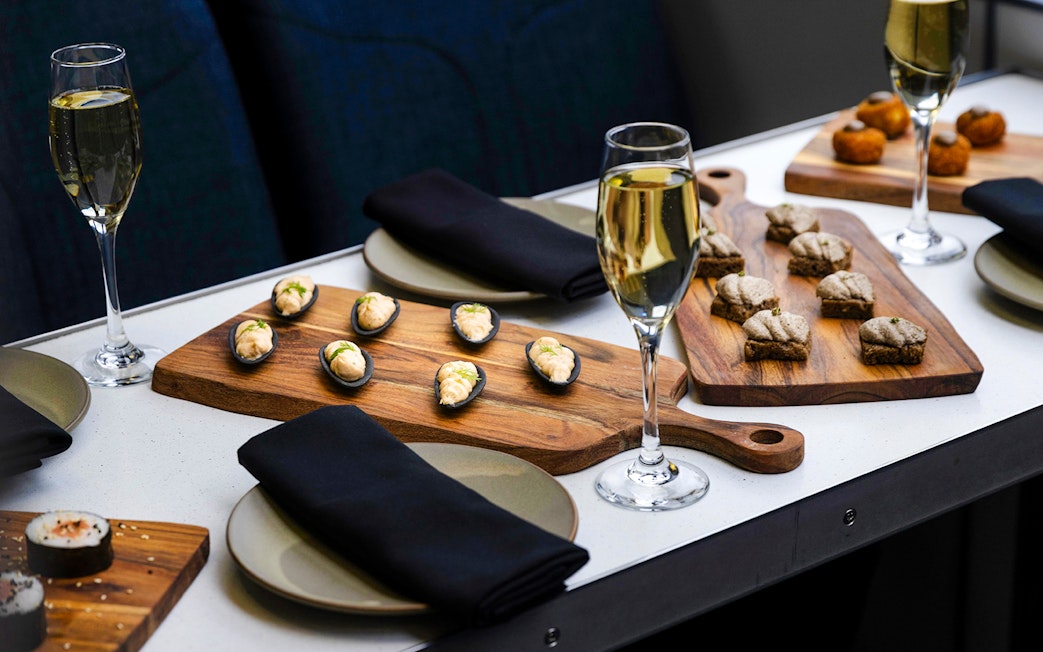 Champagne and canapes on a table during Milford Sound cruise.