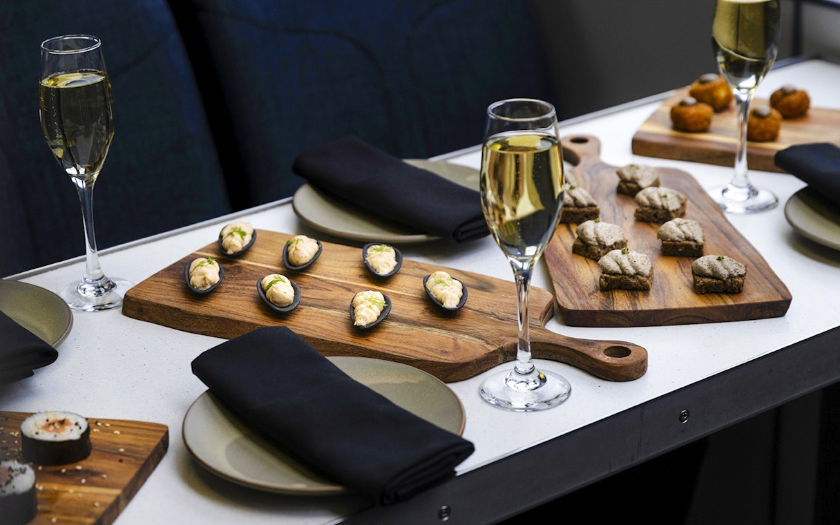 Champagne and canapes on a table during Milford Sound cruise.