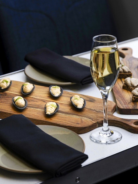 Champagne and canapes on a table during Milford Sound cruise.