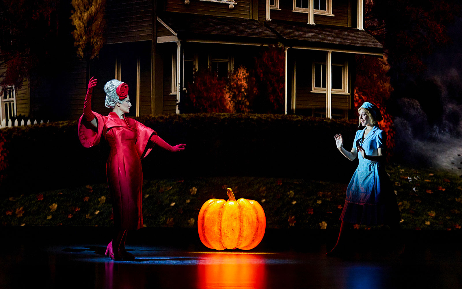 Cinderella and stepmother on stage with glowing pumpkin, Madrid performance.