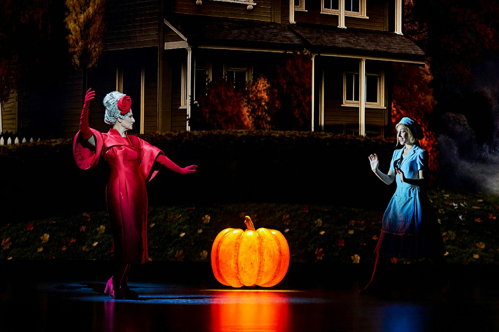 Cinderella and stepmother on stage with glowing pumpkin, Madrid performance.