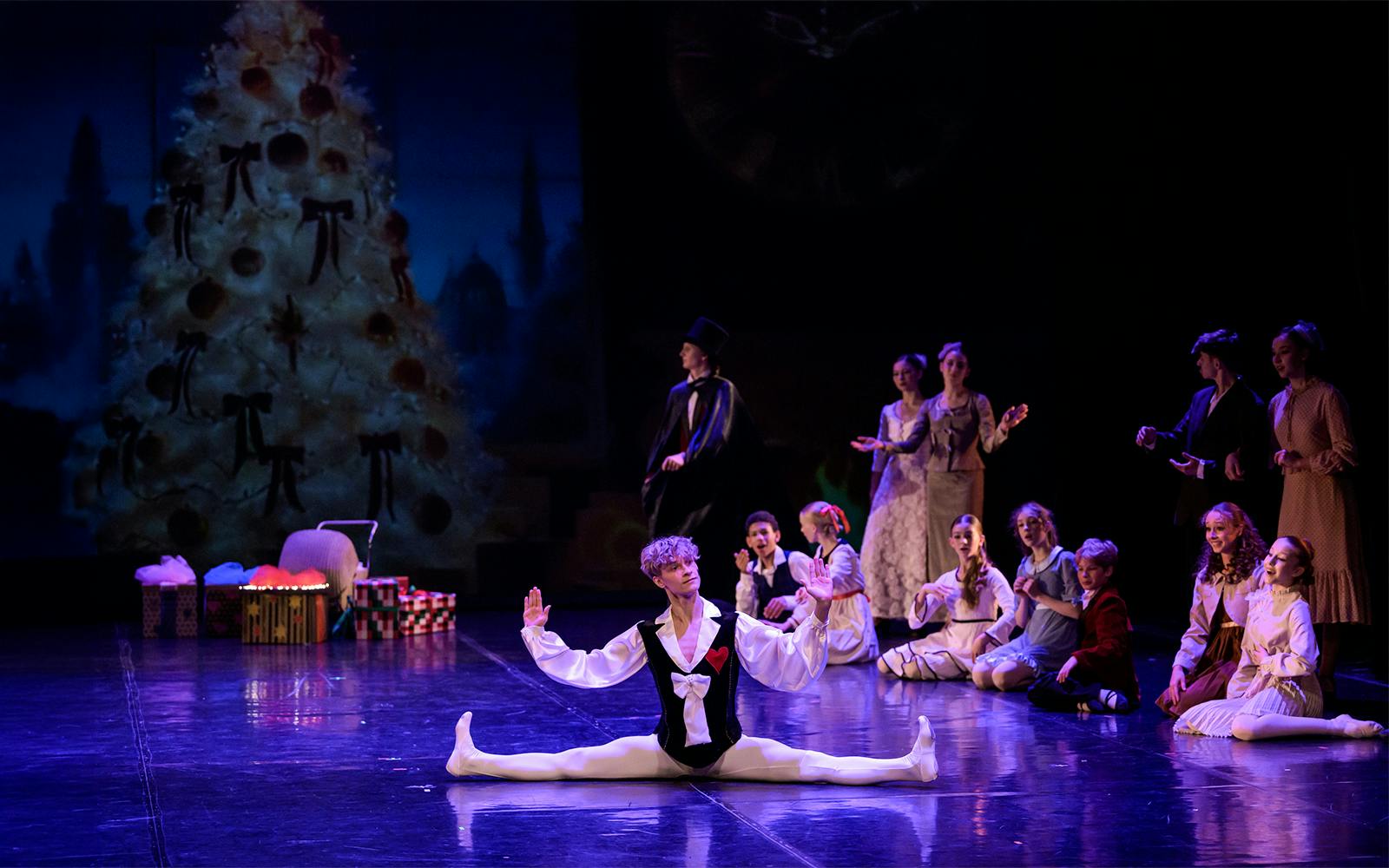 Ballet dancer performing split on stage during Prague's Old Town gala.