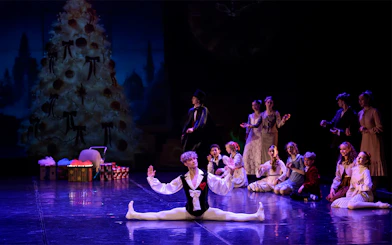Ballet dancer performing split on stage during Prague's Old Town gala.