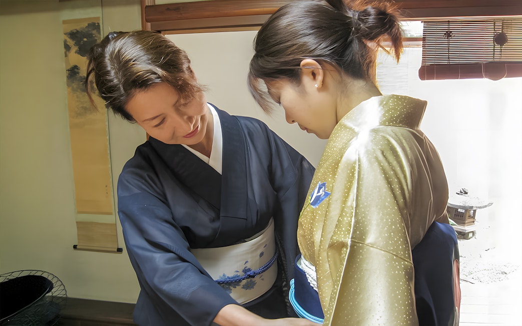 Kimono fitting during Kyoto Machiya tea ceremony experience.