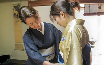 Kimono fitting during Kyoto Machiya tea ceremony experience.