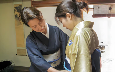 Kimono fitting during Kyoto Machiya tea ceremony experience.