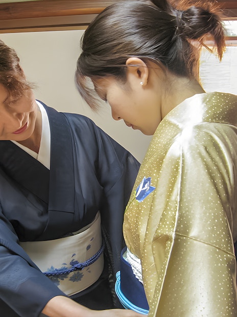 Kimono fitting during Kyoto Machiya tea ceremony experience.