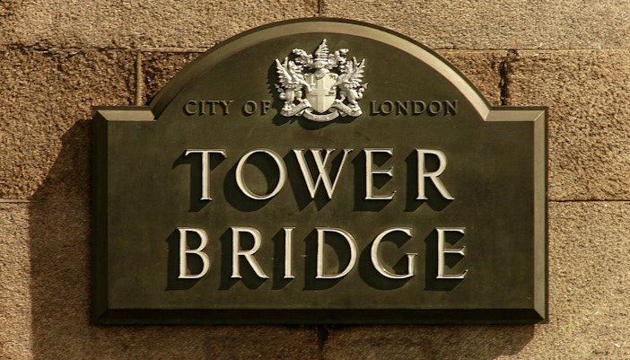 Tower Bridge sign with City of London crest.