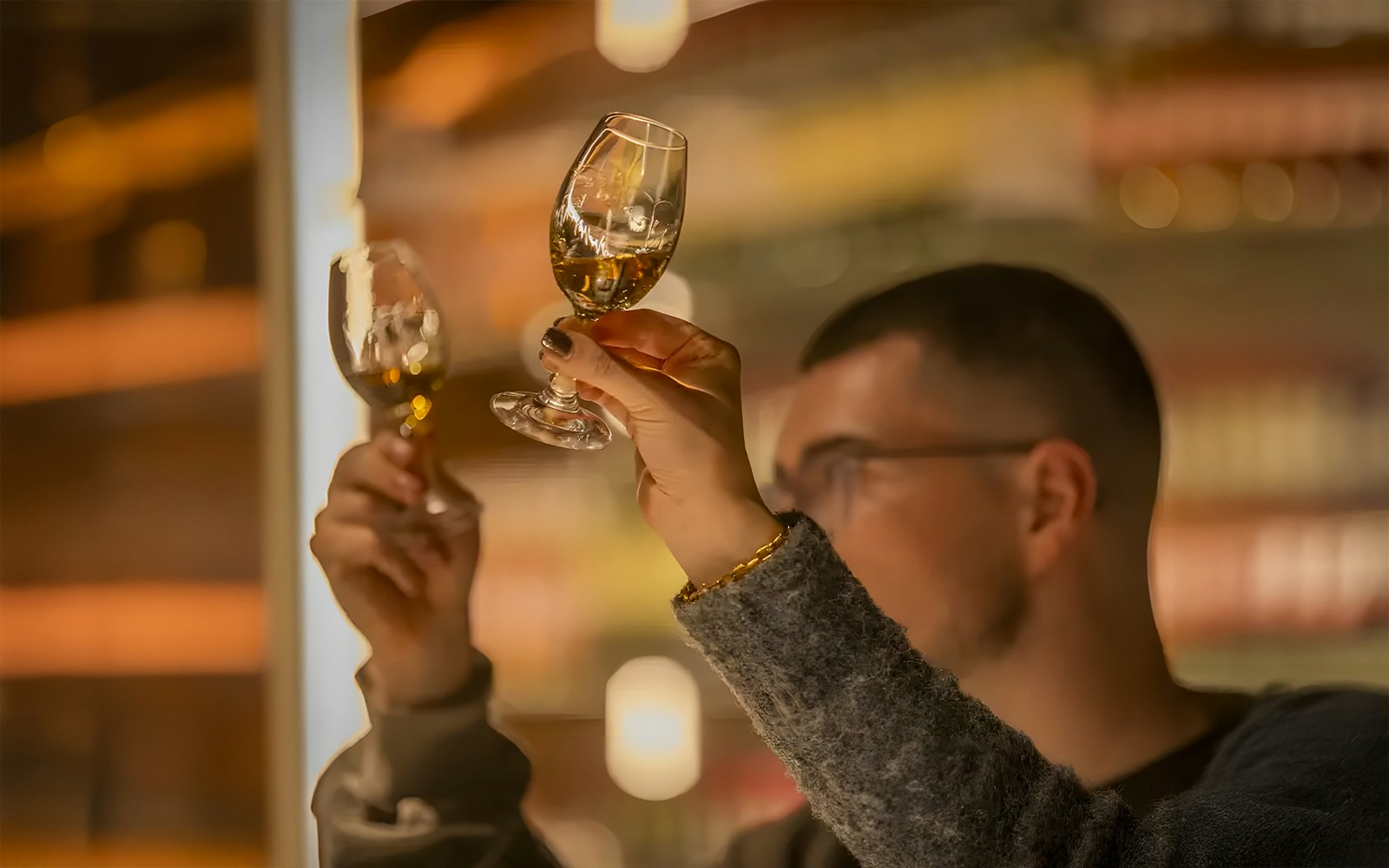 Participants examining whiskey glasses at Jameson Cocktail Making Class, Midleton Distillery.