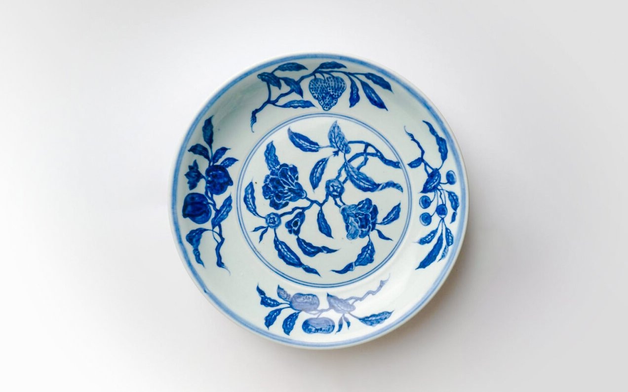 Ming Dynasty porcelain dish with blue pomegranate design.