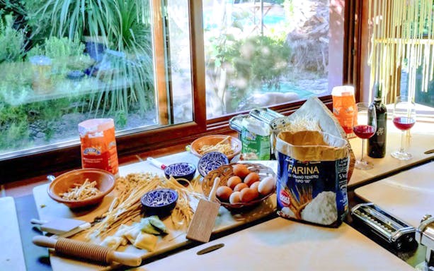 Pasta ingredients and tools on a table for a pasta-making class in Alghero.