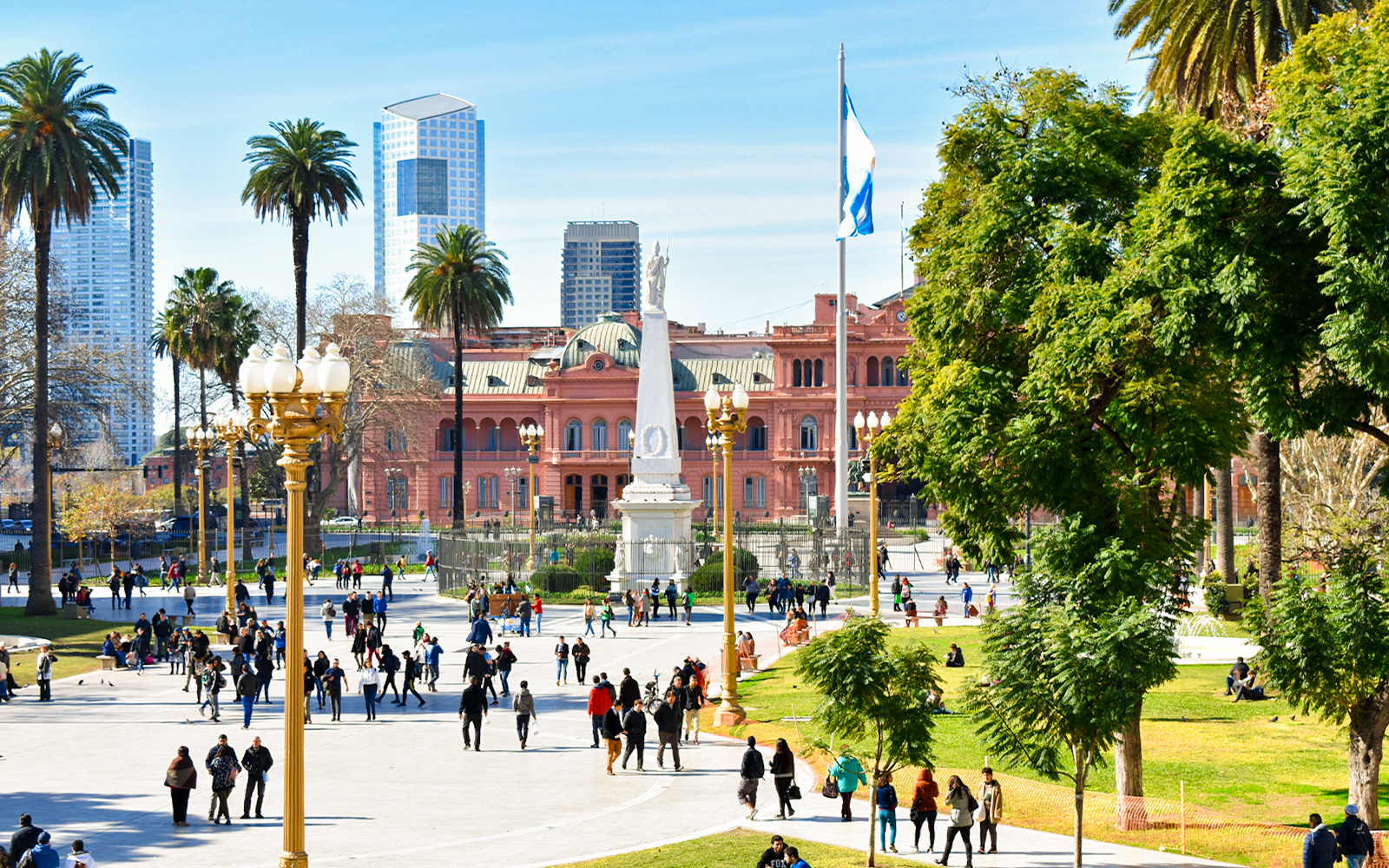 People walking in Plaza de Mayo with Casa Rosada in Buenos Aires, Argentina.