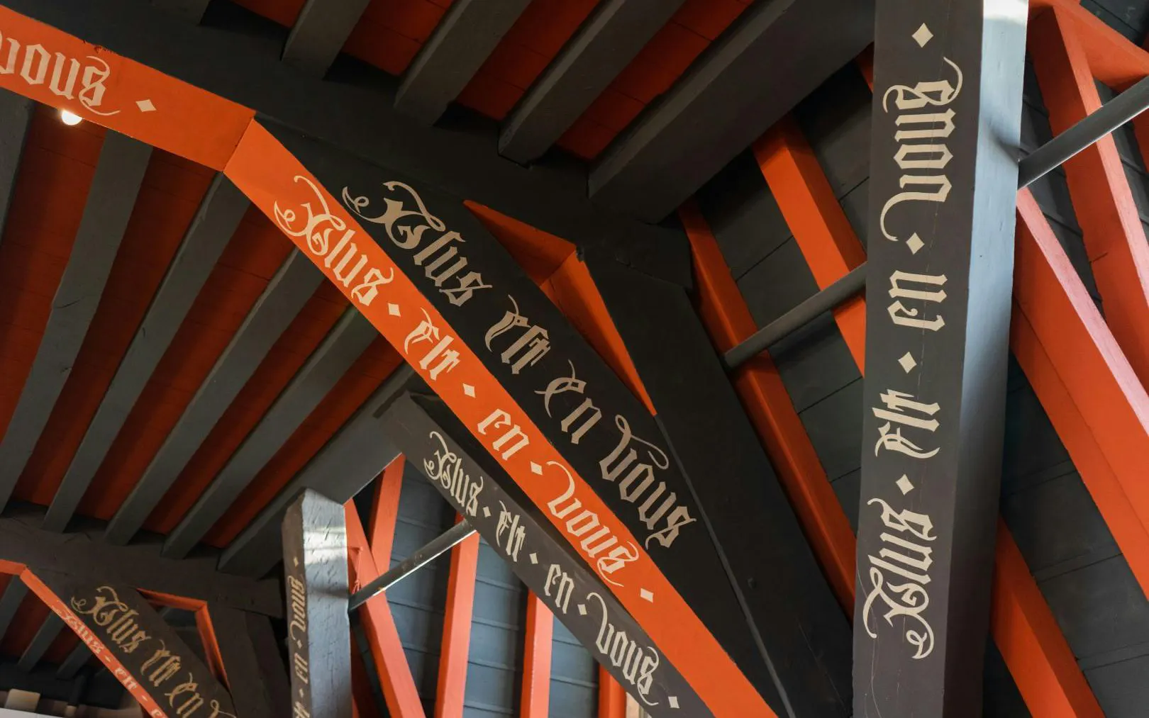 Decorative beams with Gothic script inside Gruuthusemuseum, Bruges.