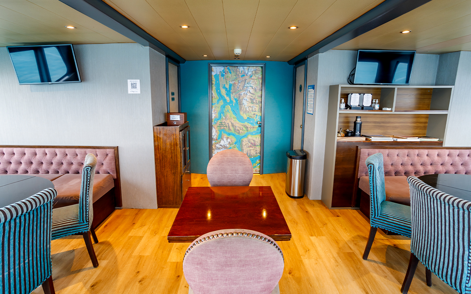 Premium boat interior with seating area and map during Perito Moreno, Spegazzini & Upsala tour.
