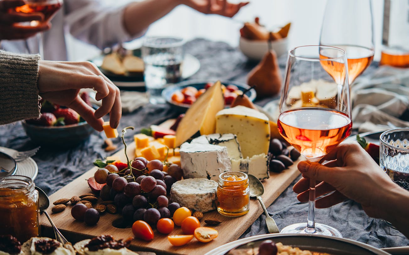 Italian cheese and wine tasting in Rome with grapes and charcuterie.