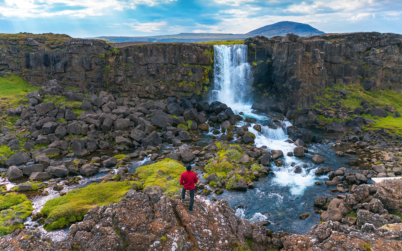 Oxararfoss Waterfall cascading over rocky cliffs in Thingvellir National Park, Iceland.