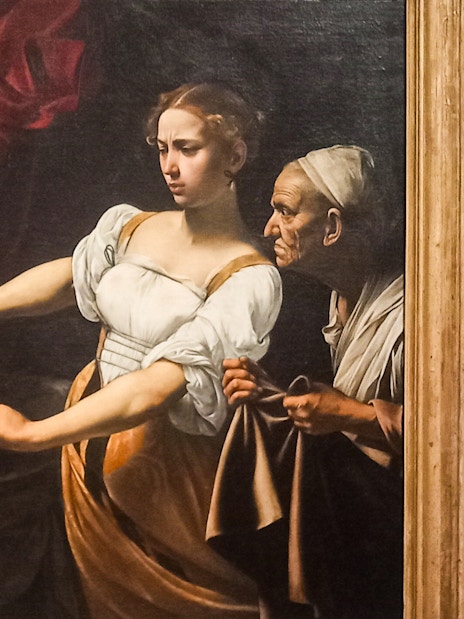 Judith Beheading Holofernes painting by Caravaggio, depicting dramatic biblical scene.