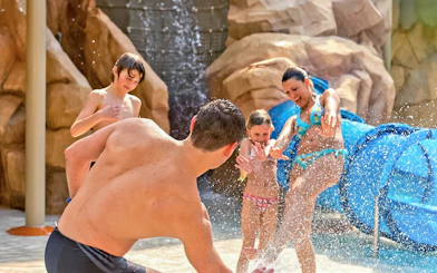 Family playing in water at Canyon Adventure zone, Aqualibi Belgium.
