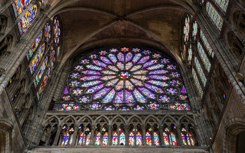 Stained glass rose window inside Basilica of Saint-Denis, Paris.