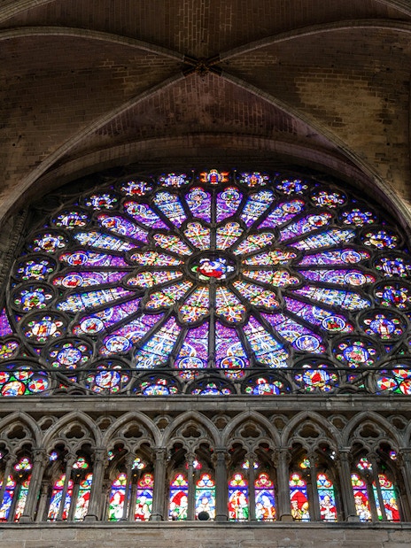 Stained glass rose window inside Basilica of Saint-Denis, Paris.
