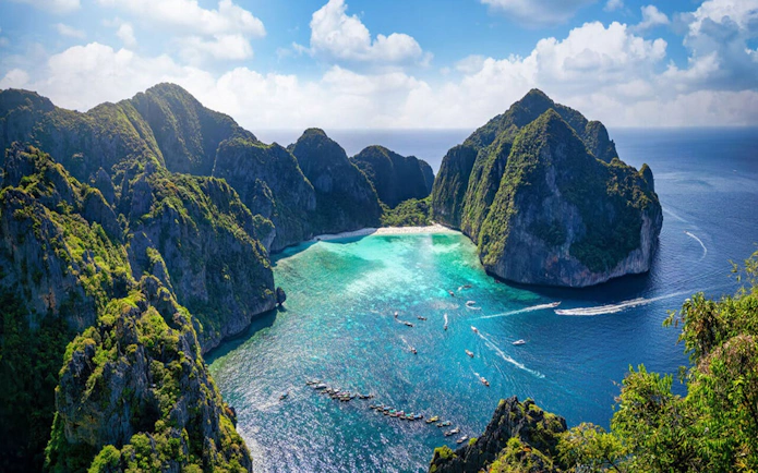 Phi Phi Islands aerial view with turquoise waters and boats, Thailand.