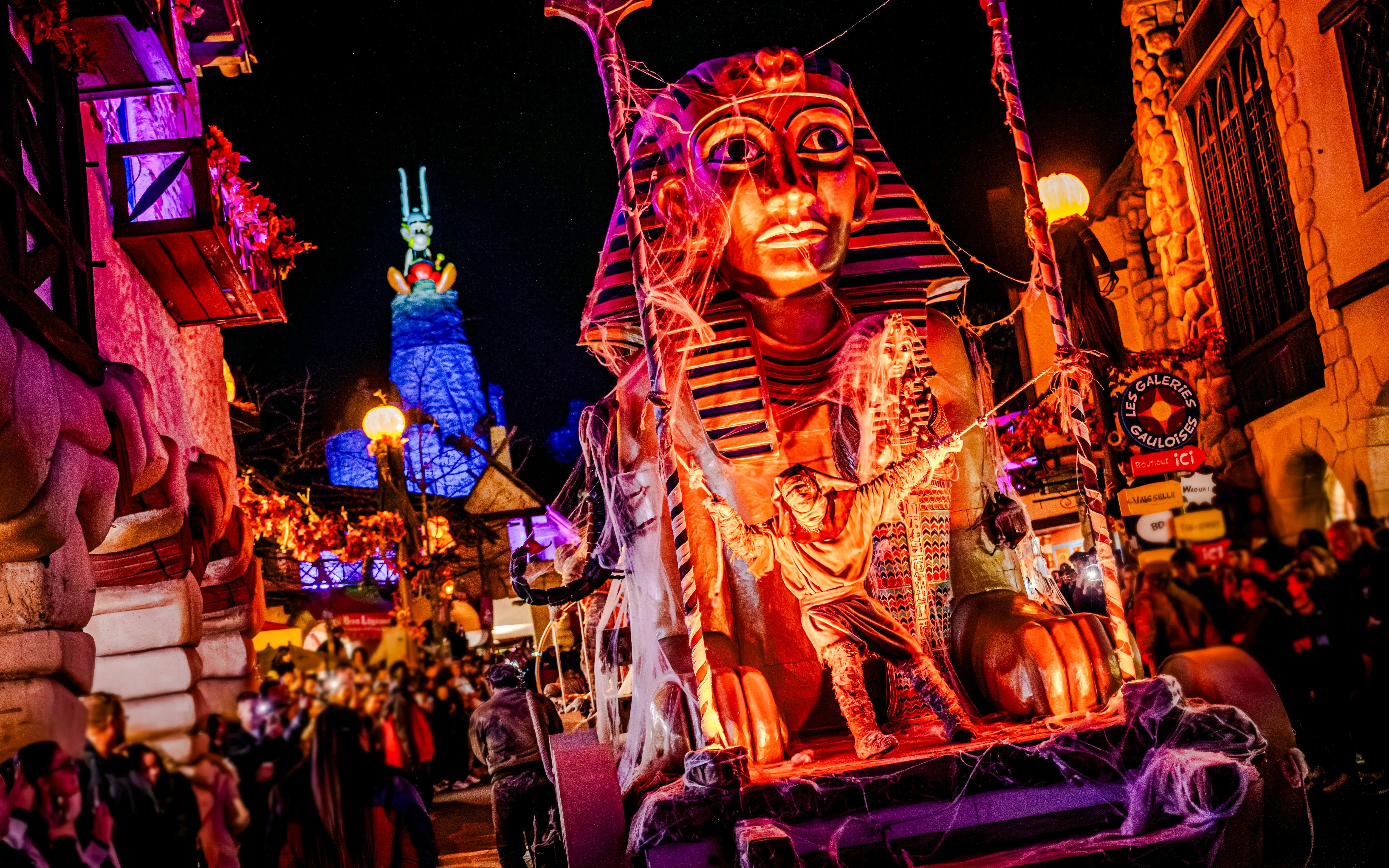 Parc Asterix Halloween event with Egyptian-themed float in Paris, France.