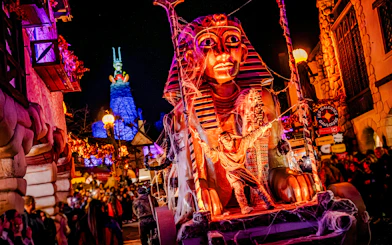 Parc Asterix Halloween event with Egyptian-themed float in Paris, France.