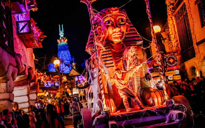 Parc Asterix Halloween event with Egyptian-themed float in Paris, France.