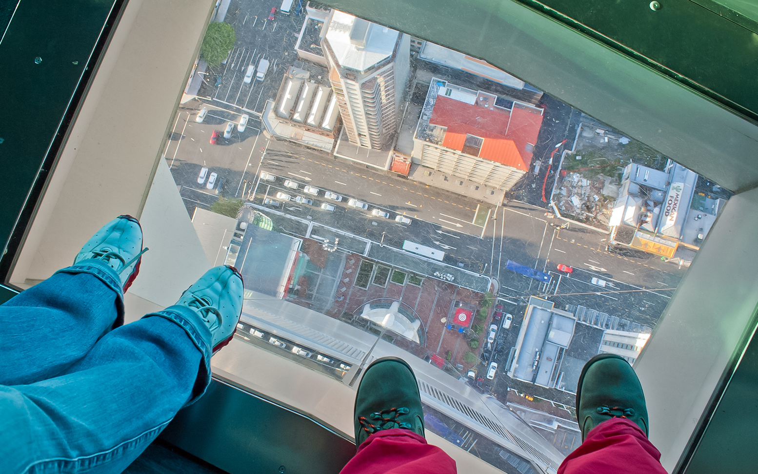 View from Skytower glass floor overlooking Auckland streets below.