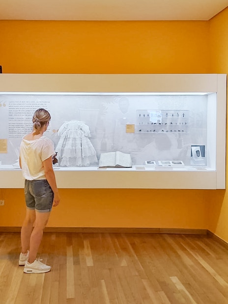 Visitor observing exhibit at Picasso's Birthplace Museum in Málaga.