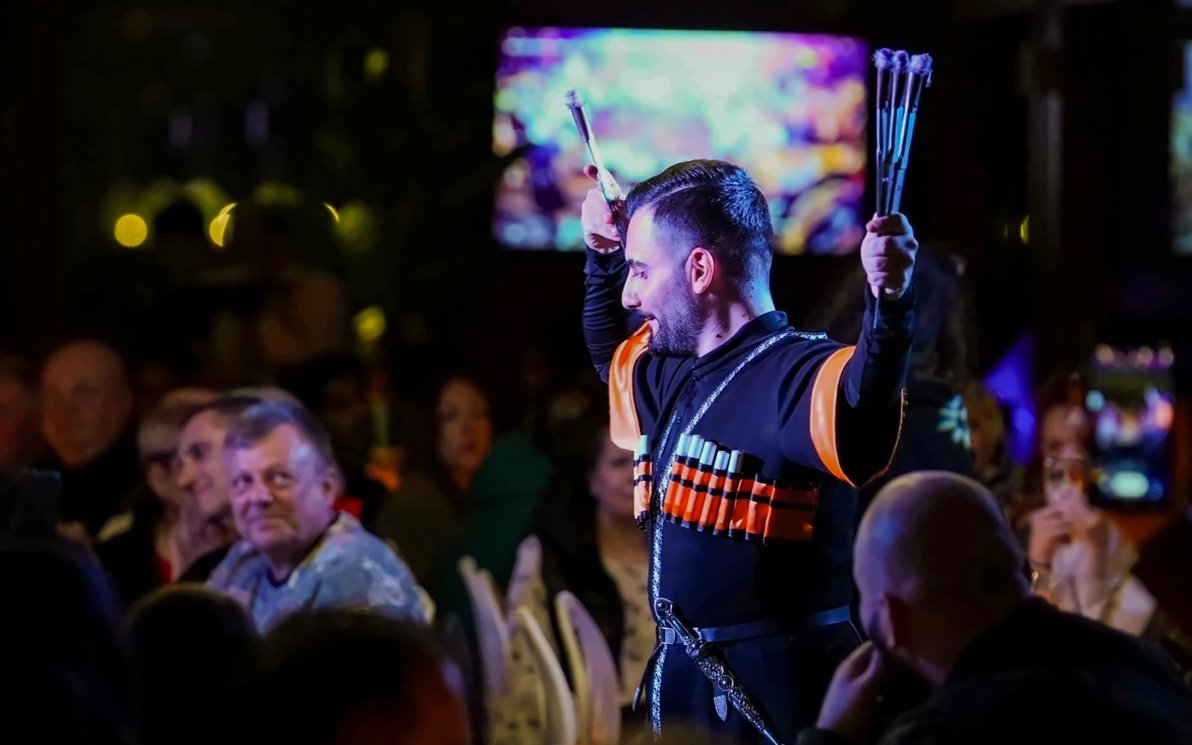Performer in traditional attire during a folk dance on a Bosphorus dinner cruise.
