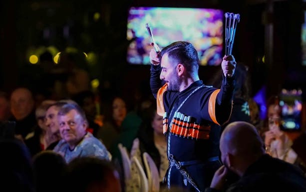 Performer in traditional attire during a folk dance on a Bosphorus dinner cruise.