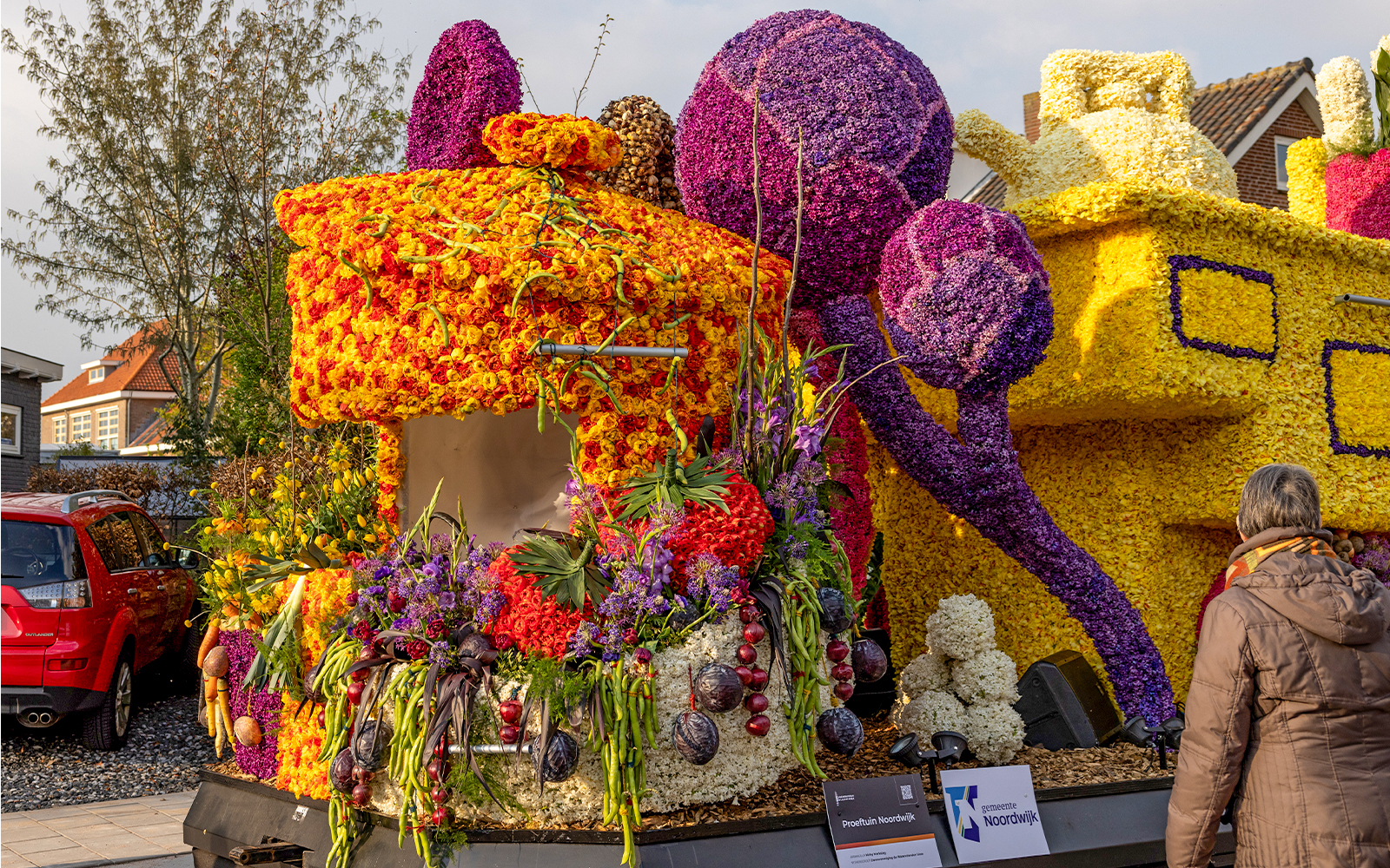 Flowers floats at evening Flower Parade Bollenstreek, Noordwijkerhout, illuminated for night display.