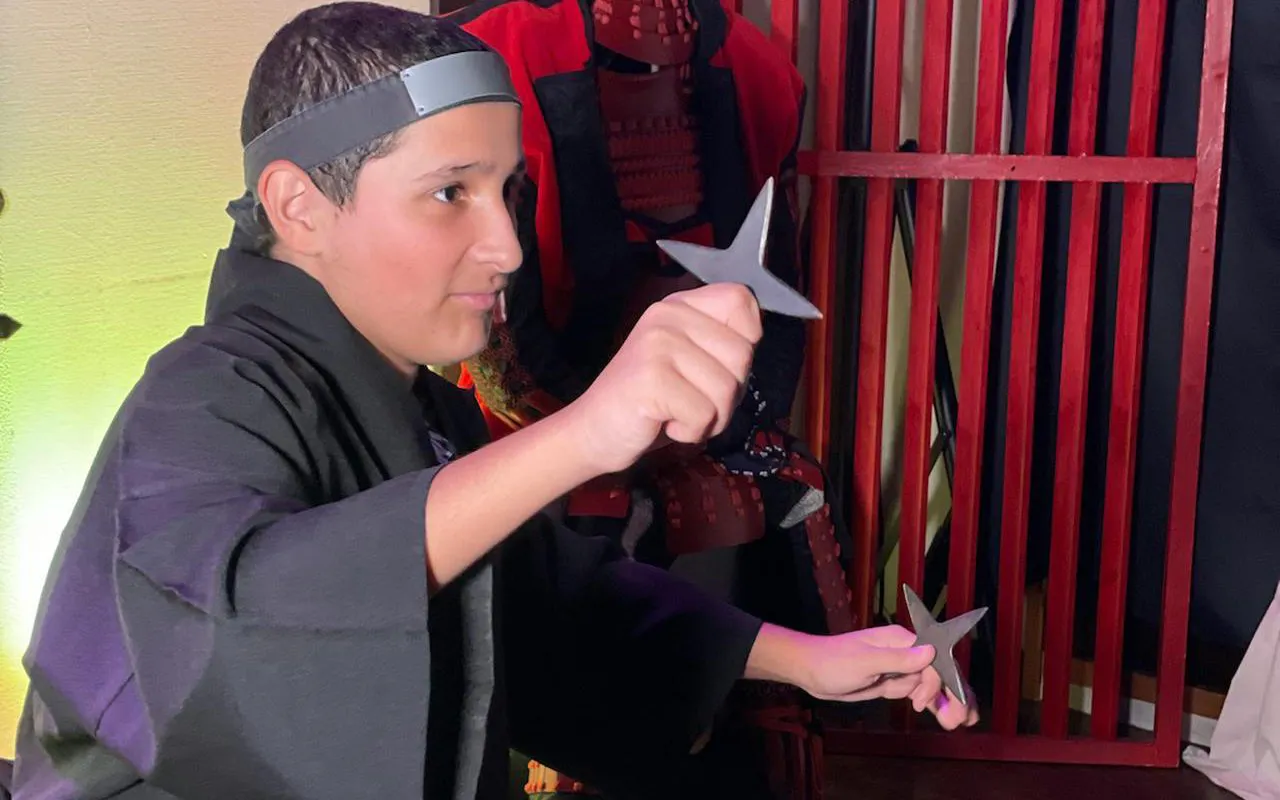 Child practicing with ninja stars at Osaka Ninja Workshop.