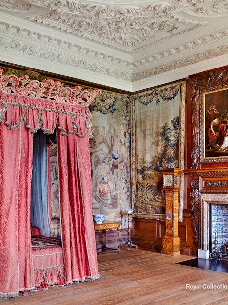 Kings Bedchamber with ornate canopy bed and tapestries at the Palace of Holyroodhouse.