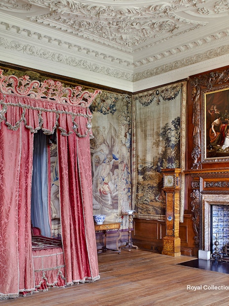 Kings Bedchamber with ornate canopy bed and tapestries at the Palace of Holyroodhouse.