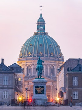 Frederik's Church dome and equestrian statue in Copenhagen at dusk.