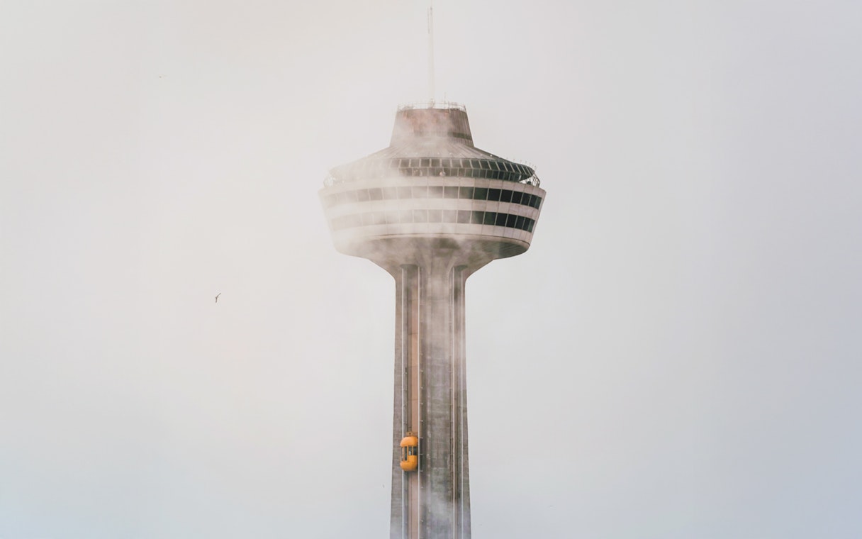 Skylon Tower in mist with yellow elevator, Ontario.