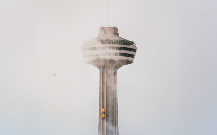 Skylon Tower in mist with yellow elevator, Ontario.