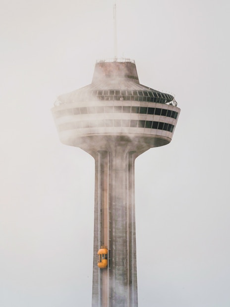 Skylon Tower in mist with yellow elevator, Ontario.
