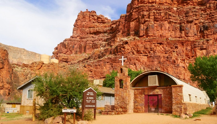 Supai Village church with red rock cliffs in Havasupai Indian Reservation, Arizona.