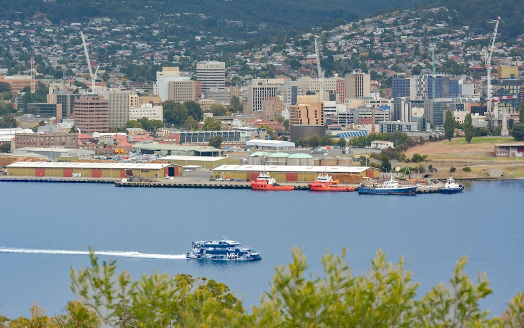 Hobart waterfront view with ferry en route to MONA, Mt Wellington in background.