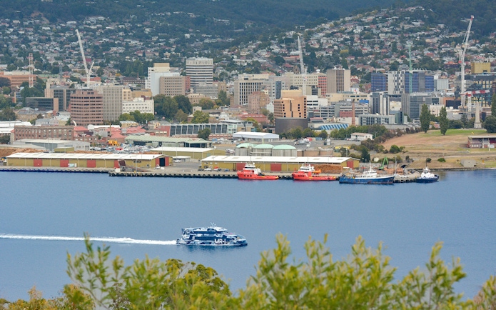 Hobart waterfront view with ferry en route to MONA, Mt Wellington in background.