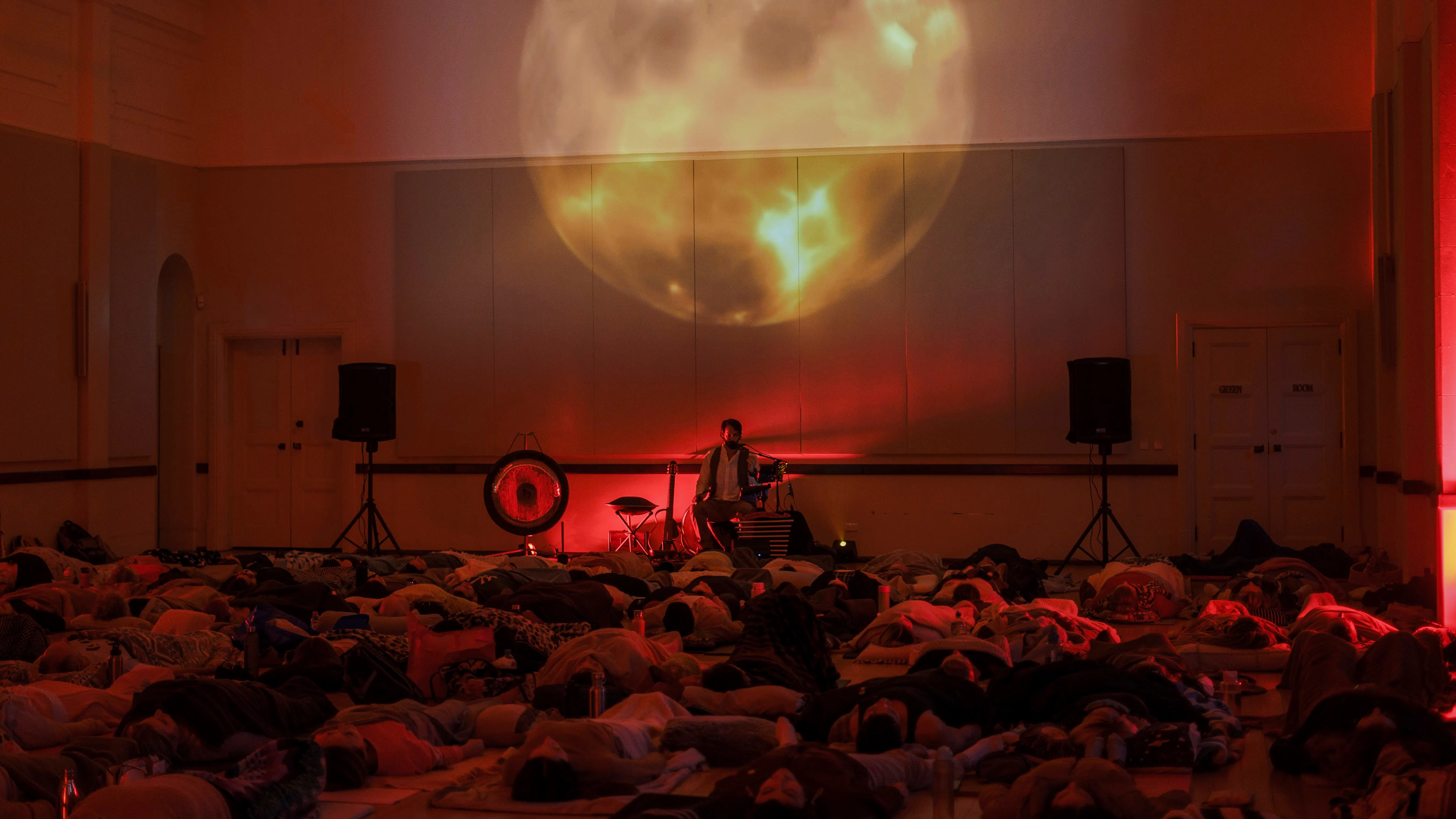 Participants lying on mats during The Sound Within immersive sound journey with Christian Dimarco in London.