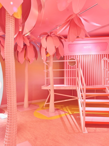 Museum of Ice Cream Singapore pink room with surfboards and palm trees.