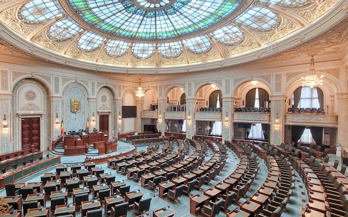 Parliament chamber with ornate ceiling inside Palace of Parliament, Bucharest.