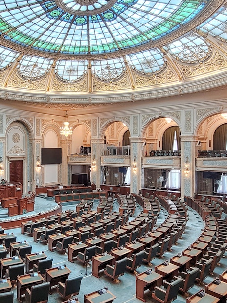 Parliament chamber with ornate ceiling inside Palace of Parliament, Bucharest.